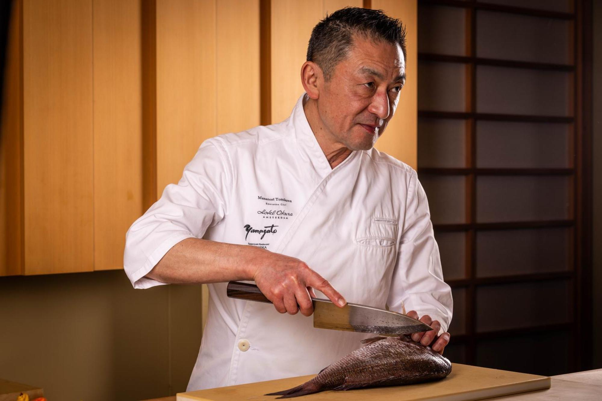 Hotel Okura Amsterdam - The Leading Hotels Of The World Exterior photo Chef preparing a fish